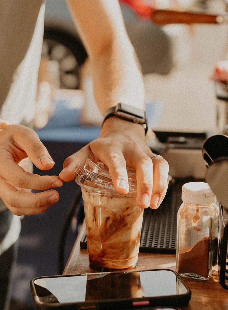 Finishing an iced coffee at the cart