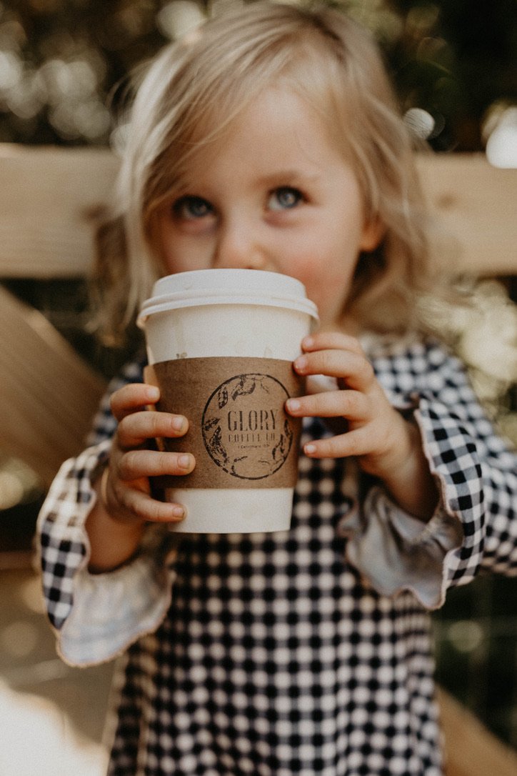 A young guest holding a Glory Coffee cup